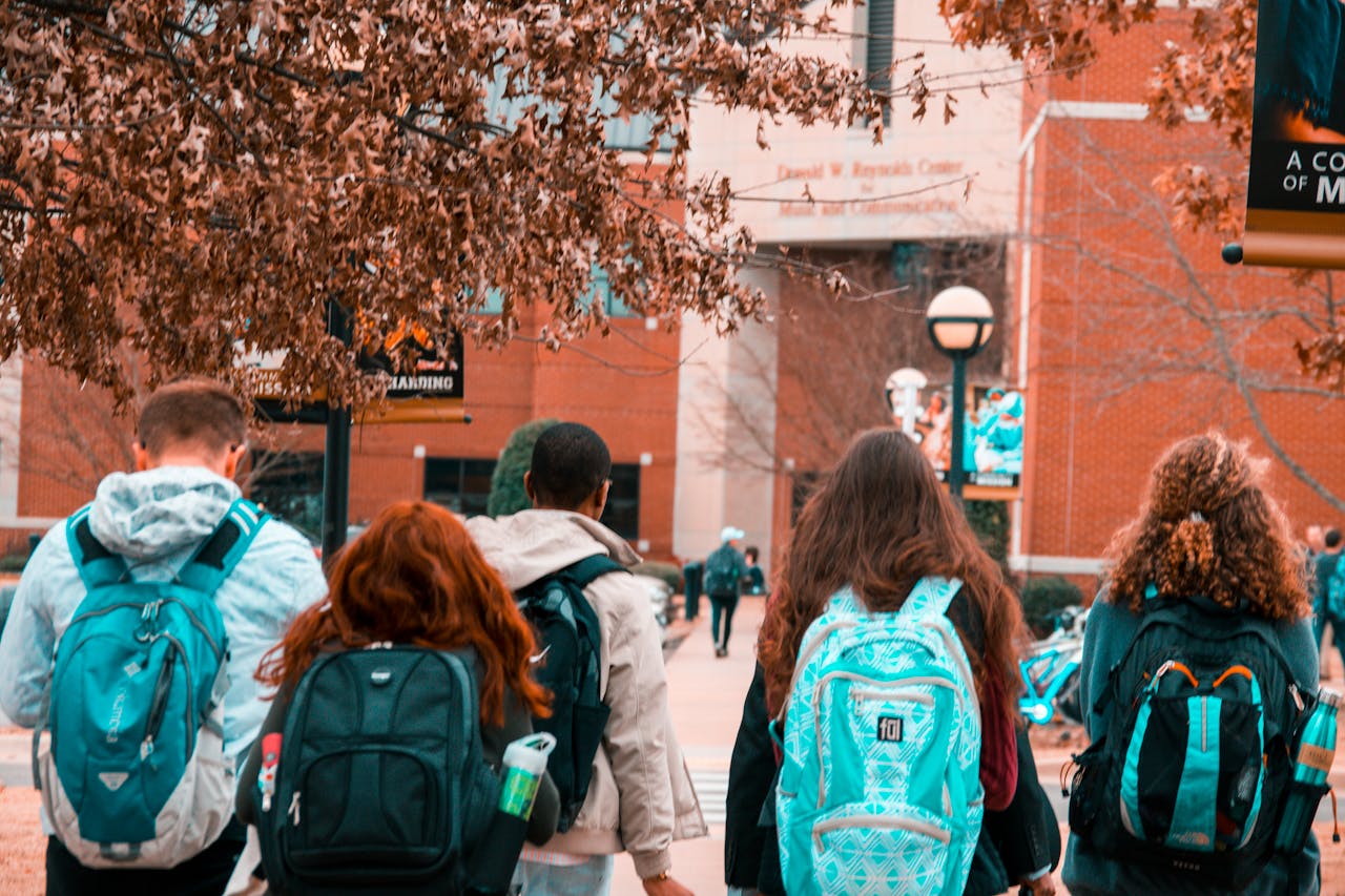 services-03 A group of college students with backpacks walking together outdoors on campus.